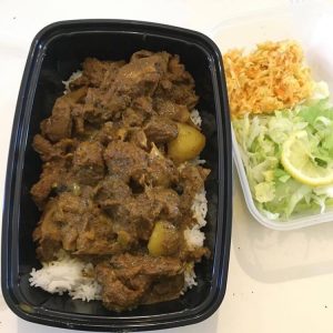 Curry Goat with White Rice, Coleslaw and Green Salad